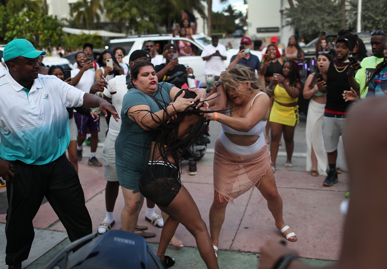 Women fight on the street near Ocean Drive on March 19, 2021 in Miami Beach, Florida.