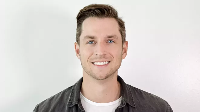 a portrait of a man in front of a white background