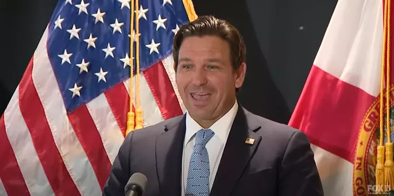Image: Ron DeSantis standing at a press conference