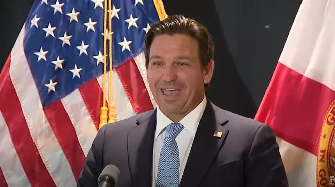 Ron DeSantis standing at a press conference