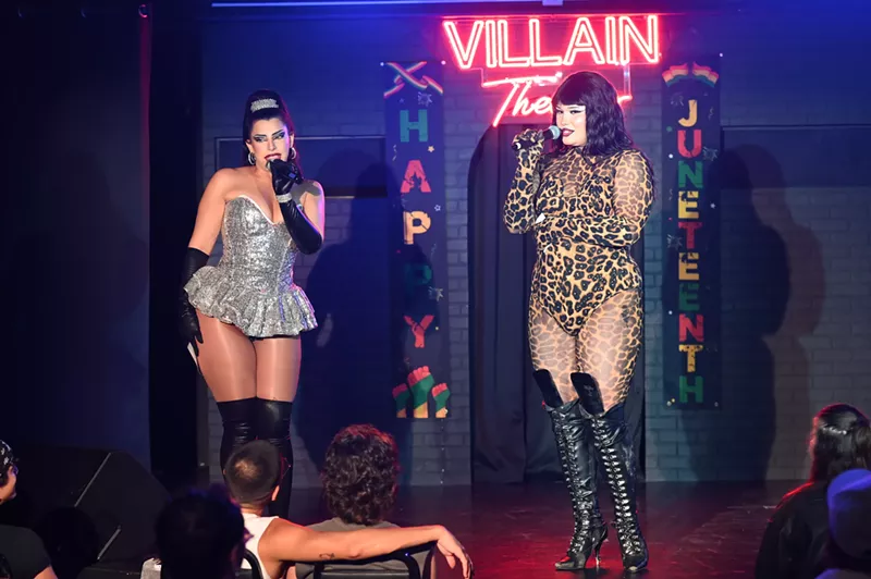 Image: Two drag performers speak on stage