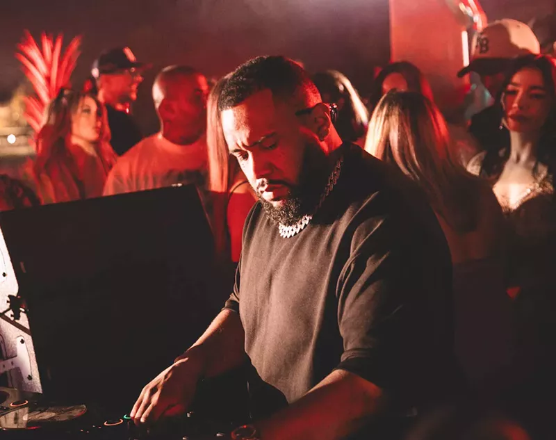 Image: Gordo spinning at the festival with a crowd of people behind him.