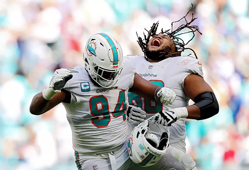 Image: Is everybody happy? Christian Wilkins (#94) and Robert Hunt (#68) certainly are.