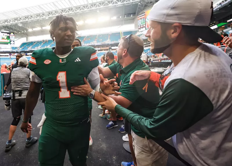 Image: MIAMI GARDENS, FLORIDA - NOVEMBER 02: Cam Ward #1 of the Miami Hurricanes high fives fans following a win over the Duke Blue Devils at Hard Rock Stadium on November 02, 2024 in Miami Gardens, Florida.