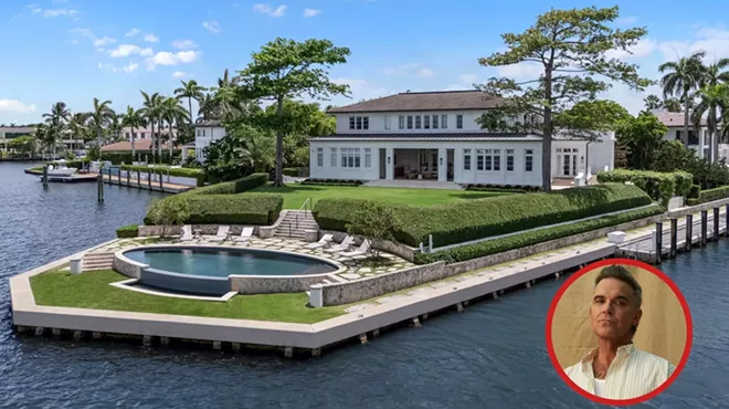 Picture of a waterfront mansion next to a portrait of Robbie Williams.