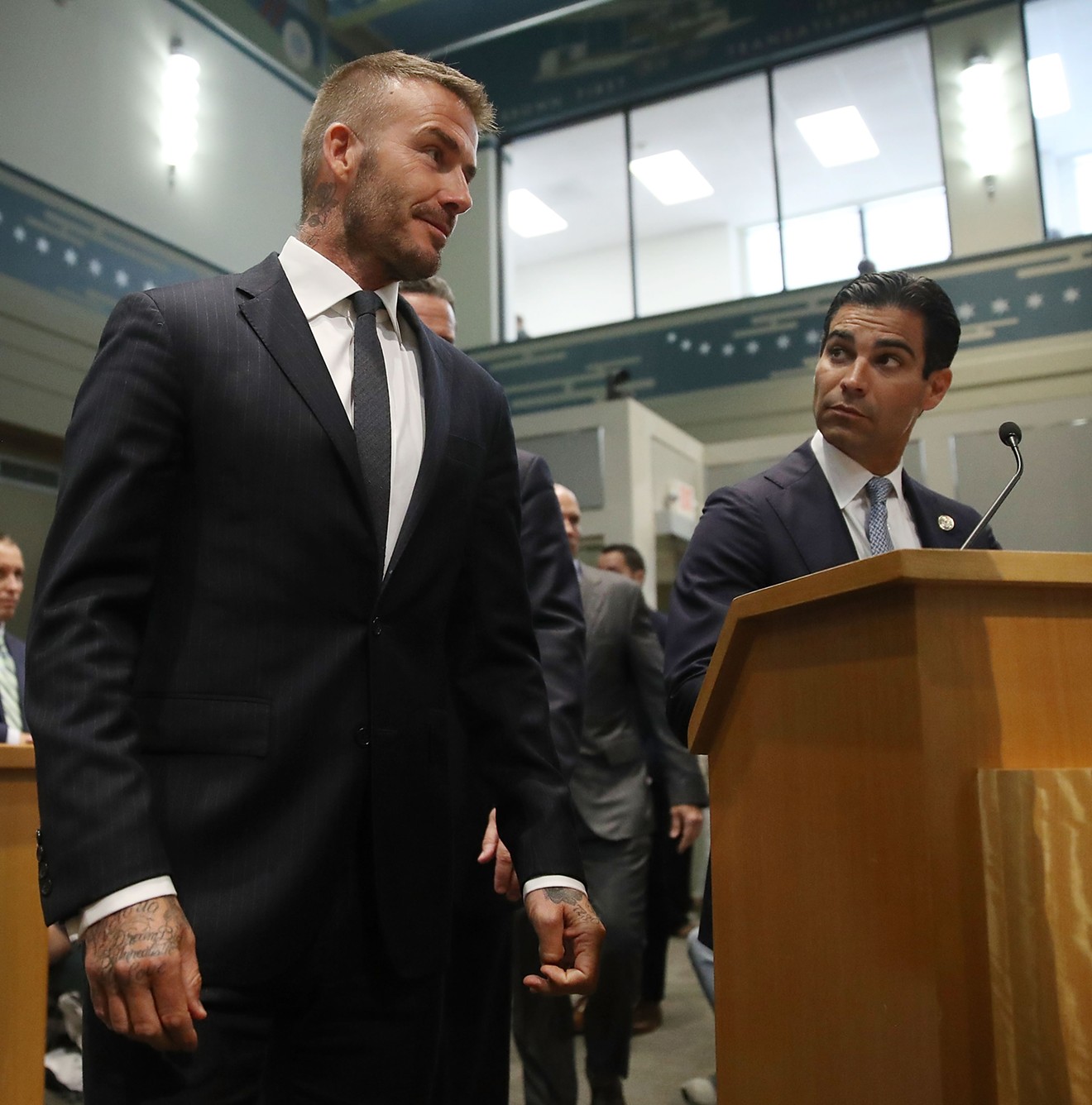 Miami Mayor Francis Suarez looks on as David Beckham arrives for a meeting at Miami city hall in July 2018.