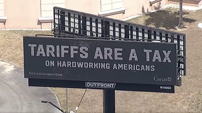screenshot of an aerial shot of a billboard that reads: "TARIFFS ARE A TAX ON HARDWORKING AMERICANS."